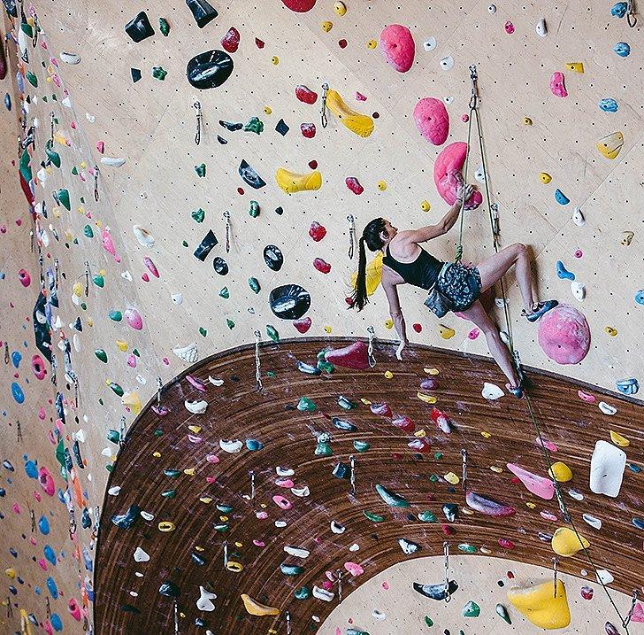 Kyra lead climbing in the gym