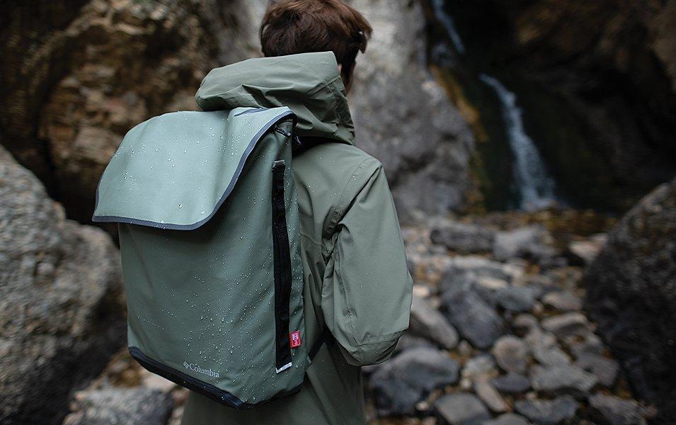 Person wearing a backpack in a rocky landscape. 