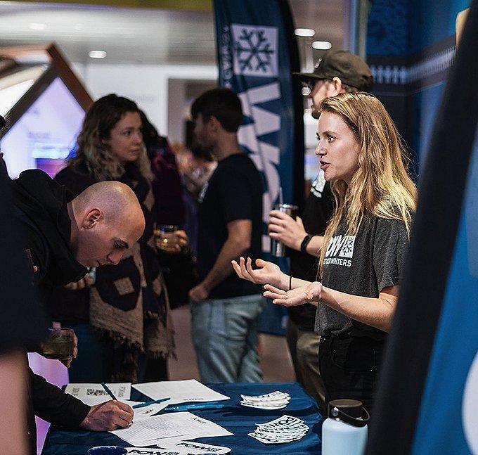 At the POW booth a person learns more about the organization