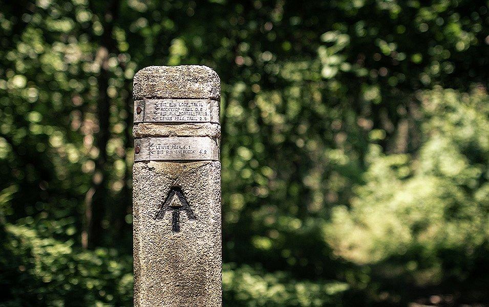 A stone and metal signpost marks the Appalachian Trail.