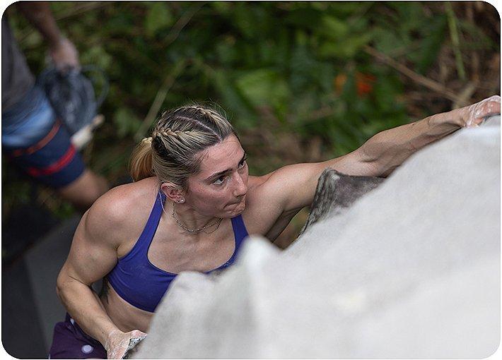 Kyra Condie reaching for the next hold while climbing in Puerto Rico