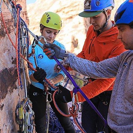 In a climbing clinic by The Mountain Guides, they show a participant all the ins and outs of clipping in and creating an anchor.