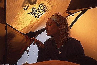 From the archives - close up of one of the founding MHW employees, in a tent looking for her headlamp