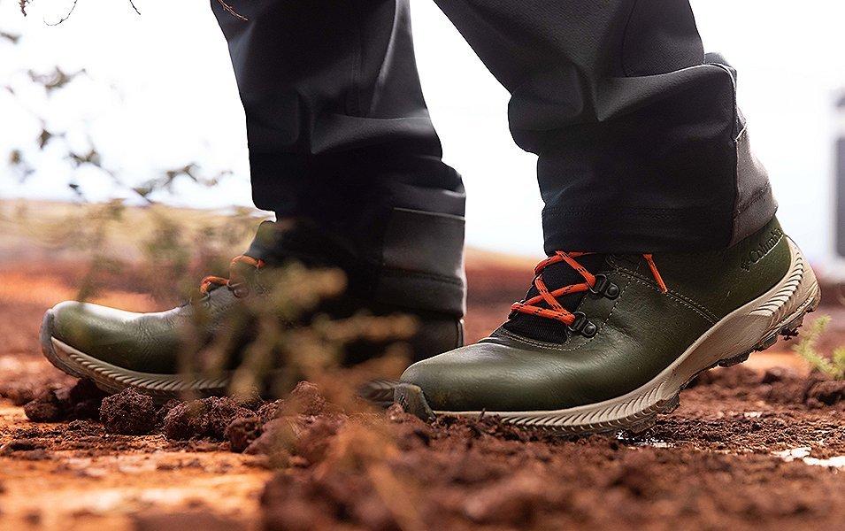 A close-up of a pair of Columbia Sportswear shoes stand in the dirt outside during an overlanding trip.