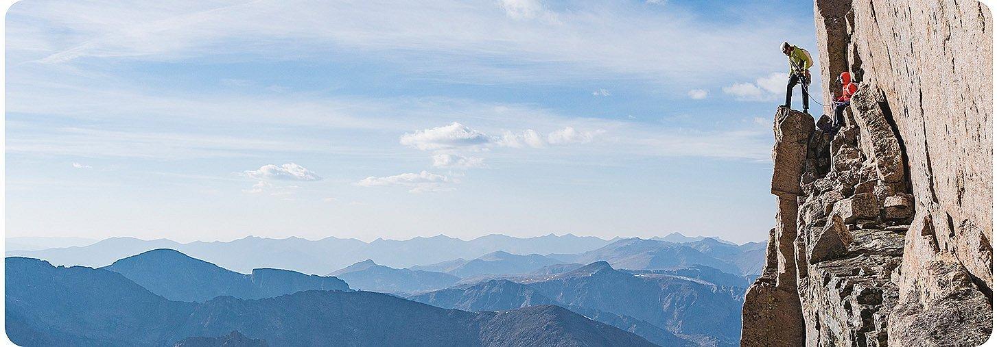 Alpinist looks over the edge.