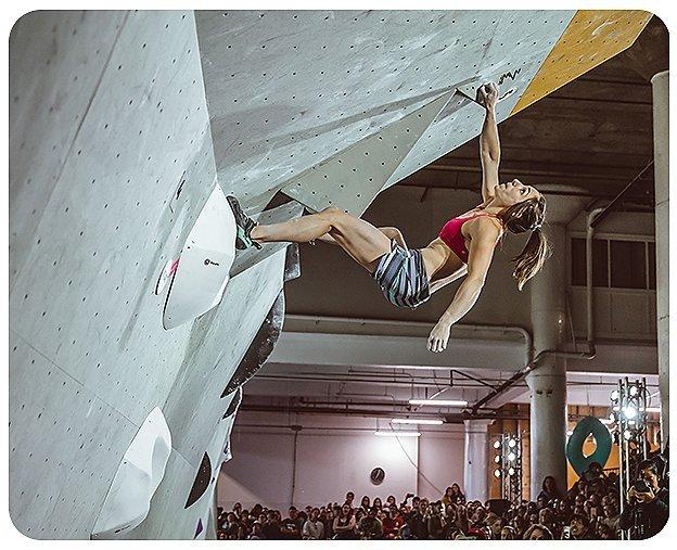 Climber reaches for their next hold during a climbing competiton at the 2019 Woman Up Event.