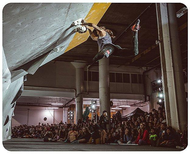 Climber reaches for their next hold during a climbing competiton at the 2019 Woman Up Event.