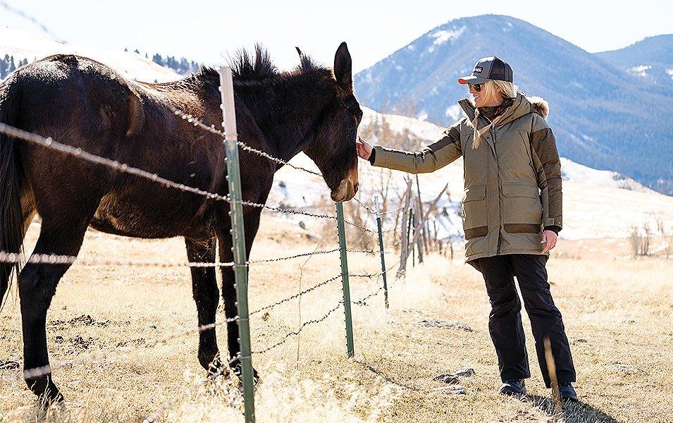 Nicole Combs petting a horse. 