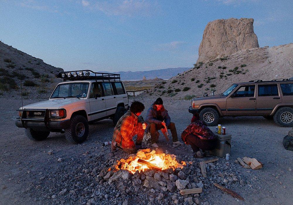 Friends around a campfire in the desert.