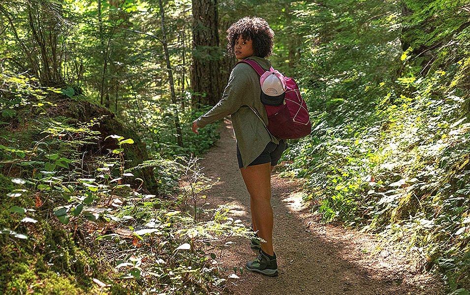 Female hiking on trail in woods 