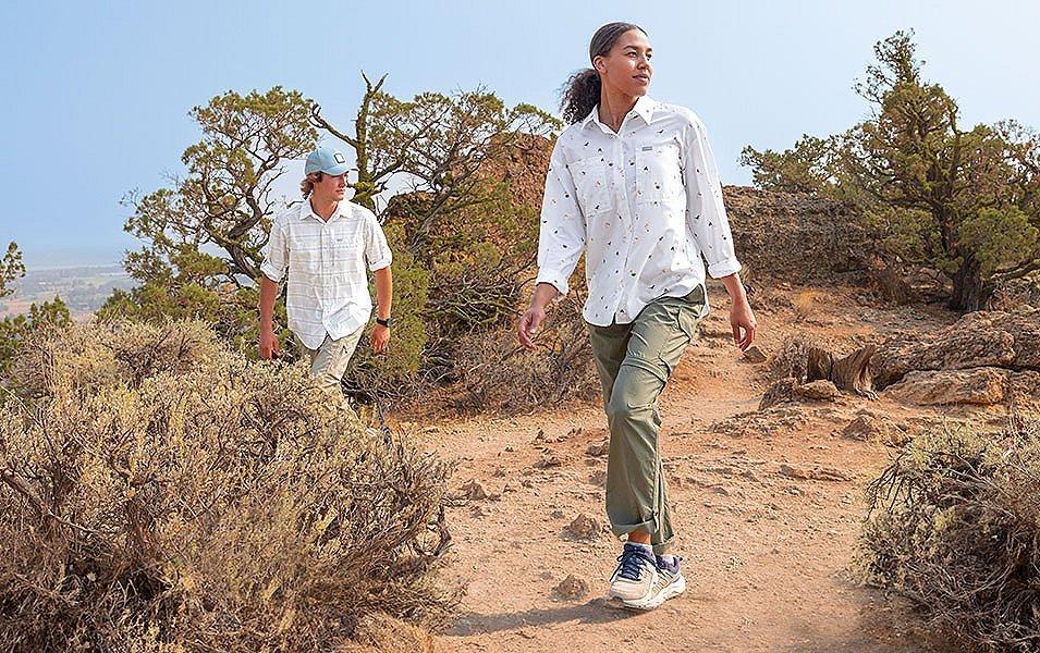 Woman and man hiking in dry desert climate 