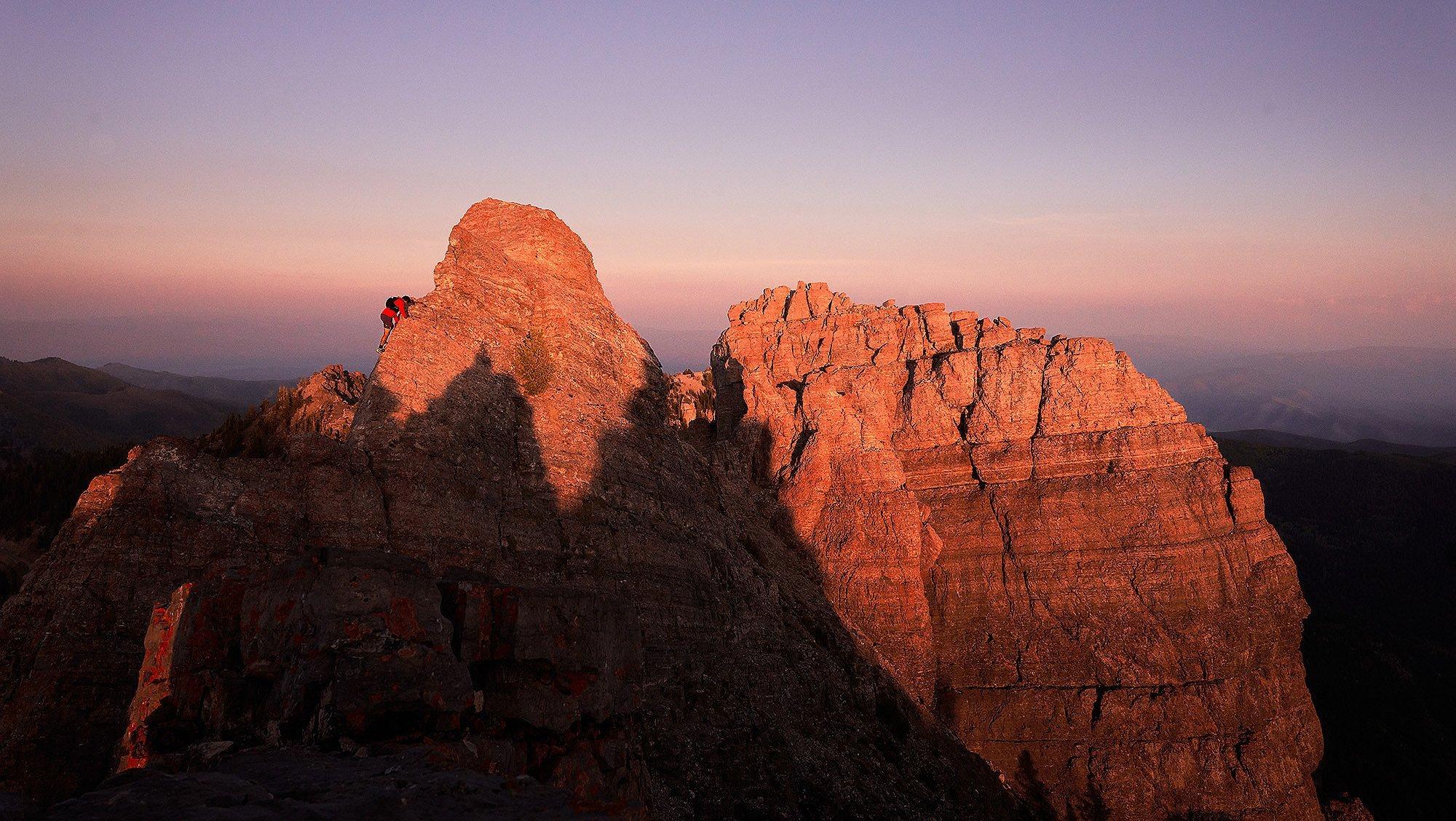 MHW Athlete Ted Hesser running at dusk on a trail ridge.