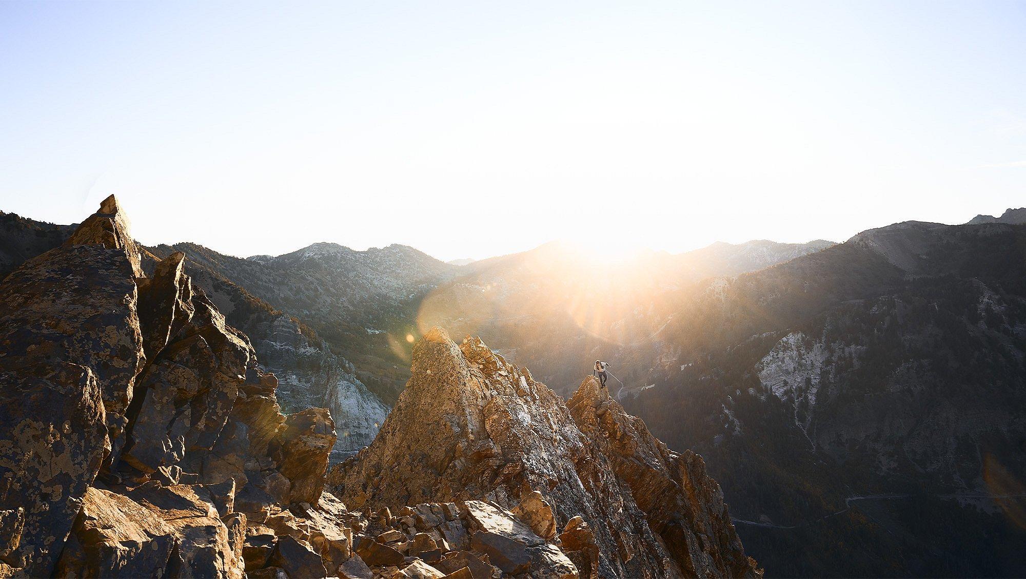 MHW Athlete Ted Hesser trail runs on a mountain ridge at sunrise.
