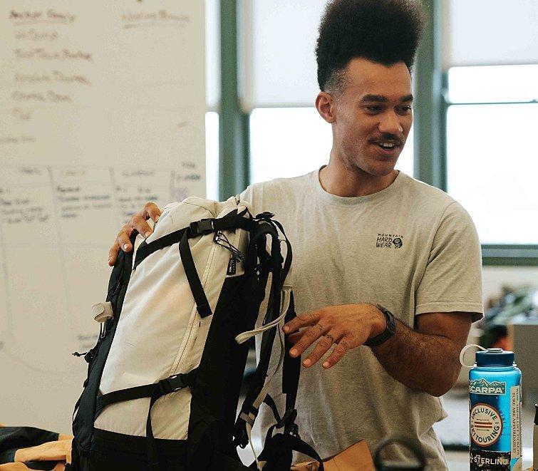 Bryce sharing feedback on the AMG pack with the equipment team at Mountain Hardwear HQ.