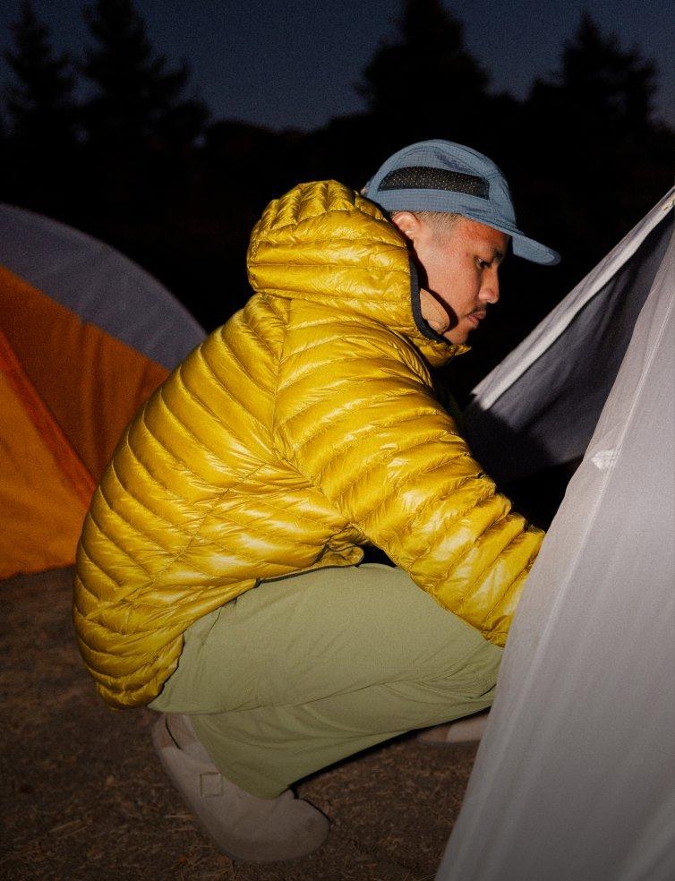 A camper setting up his tent