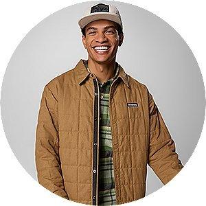A man smiling in fall layers.
