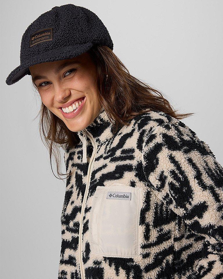 Woman in a fleece and ballcap.