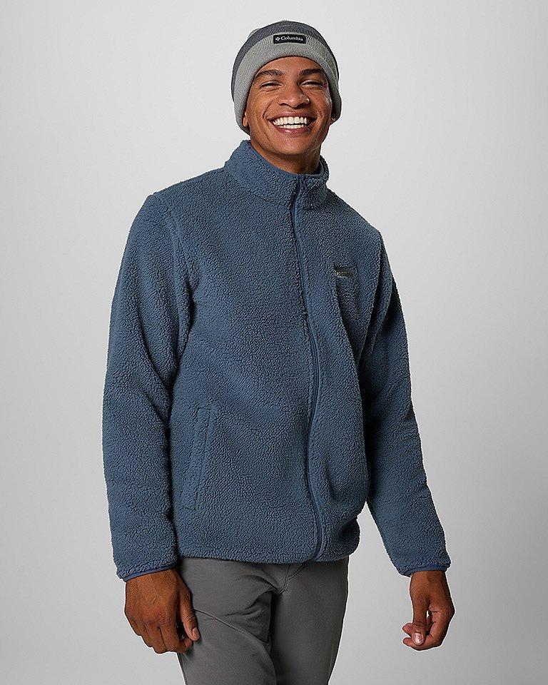 A man in a cozy fleece outdoor outfit.