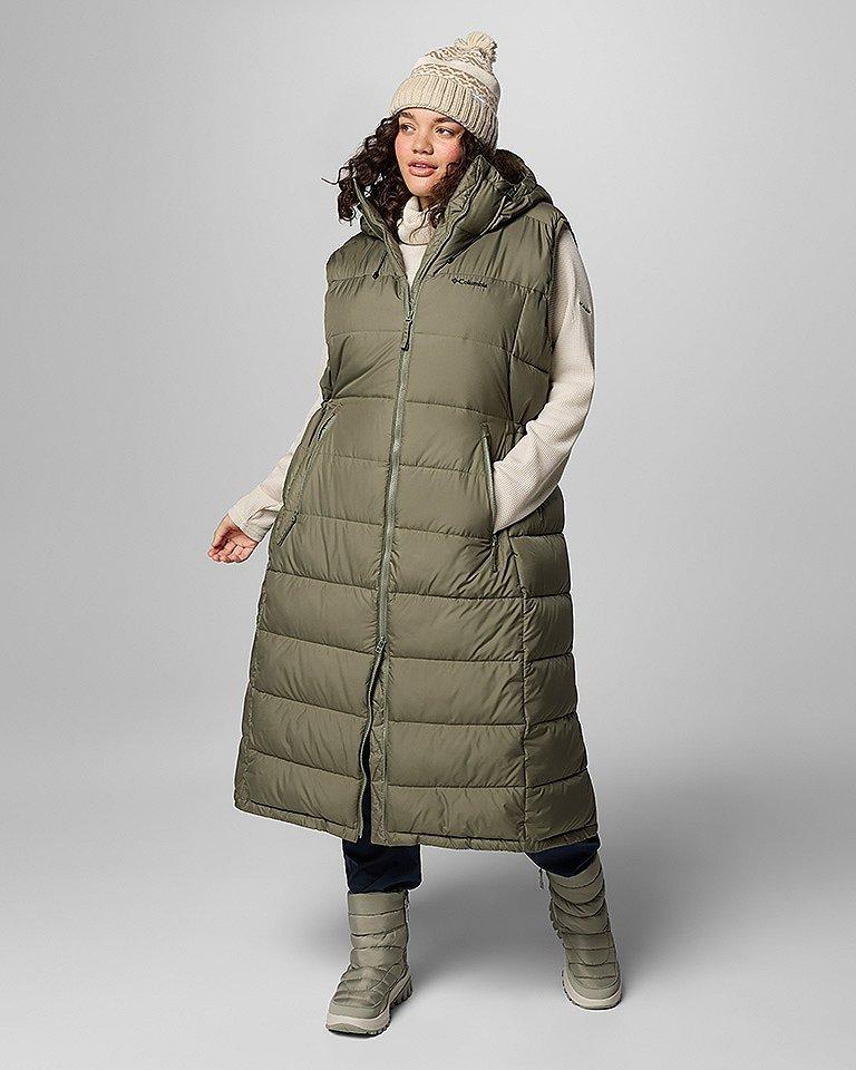 Woman in a long green puffer vest.