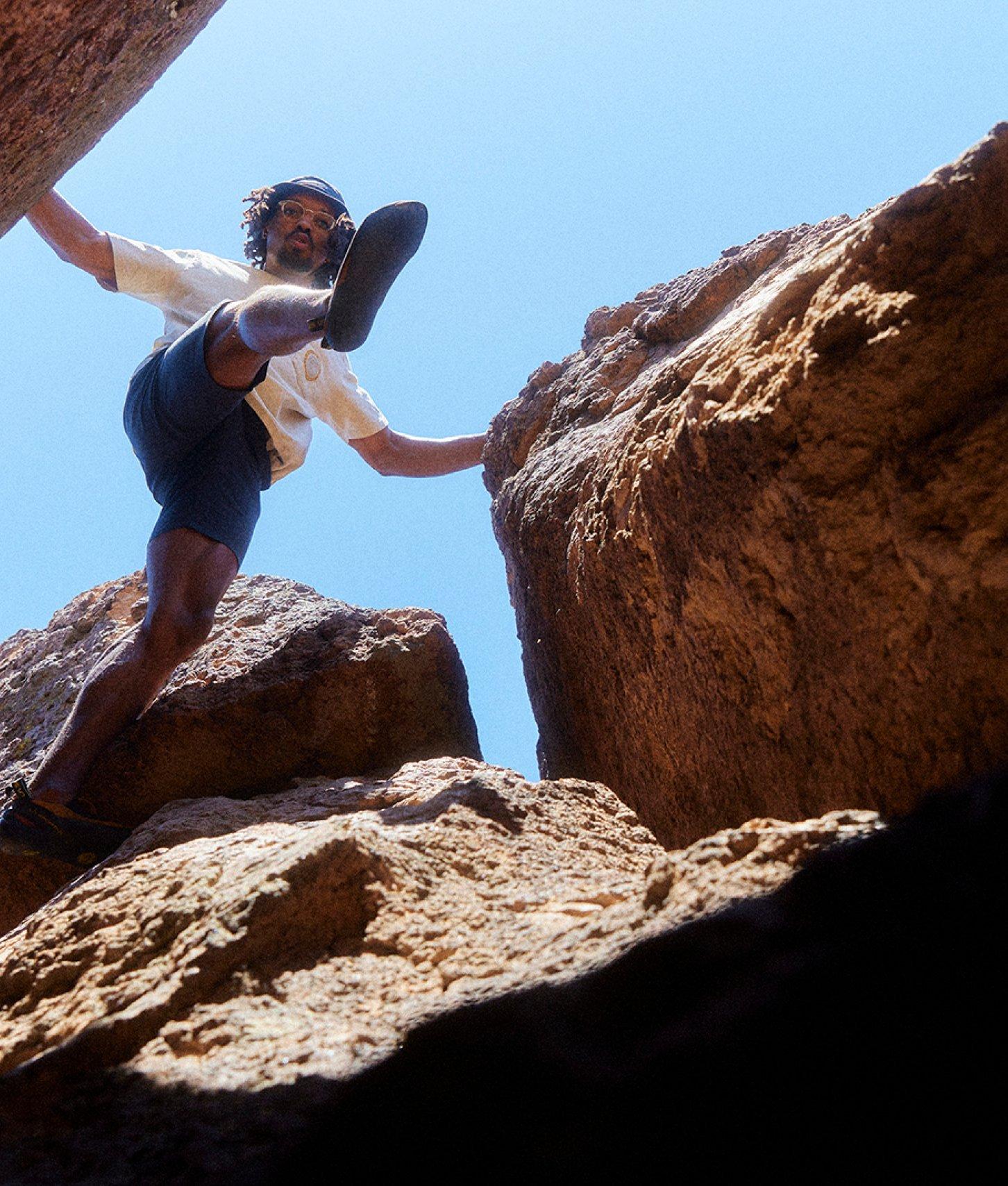 MHW Athlete Caleb Robinson moves from rock to rock while bouldering.