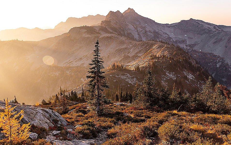 The sunset casts a beautiful orange light over the mountains at North Cascades National Park in Washington state. 