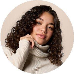 A close-up of a woman wearing a cozy sweater.