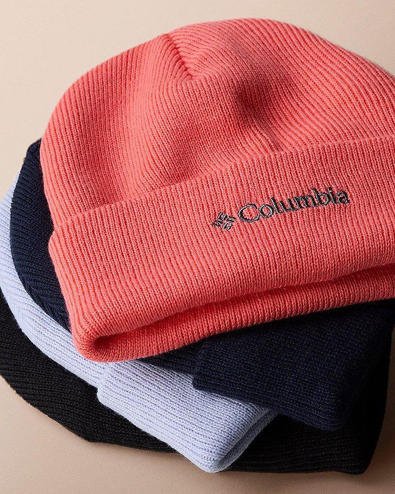 Colorful beanies stacked on top of each other. 