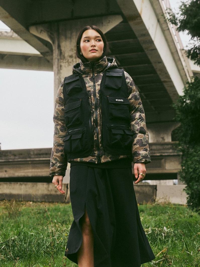 Woman in black puffy jacket and vest