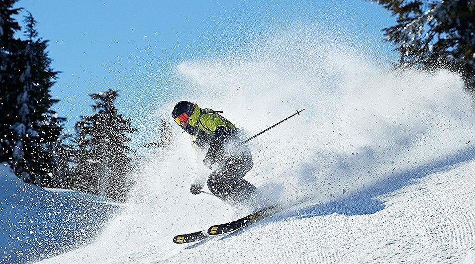 A skier carving on groomed snow.