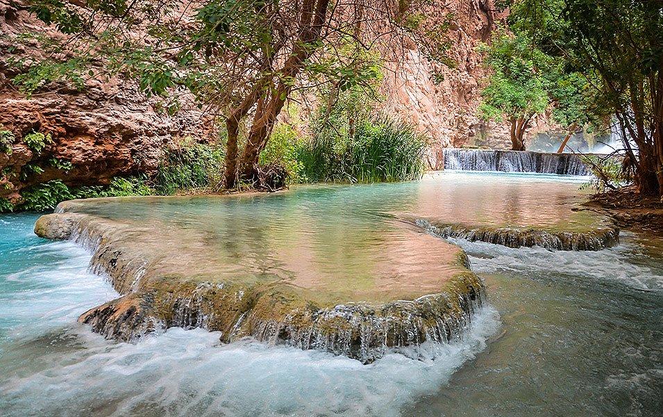 Vivid blue-green water flows along Havasu Creek as it cuts through the Havasu Indian Reservation enroute to Havasu Falls.