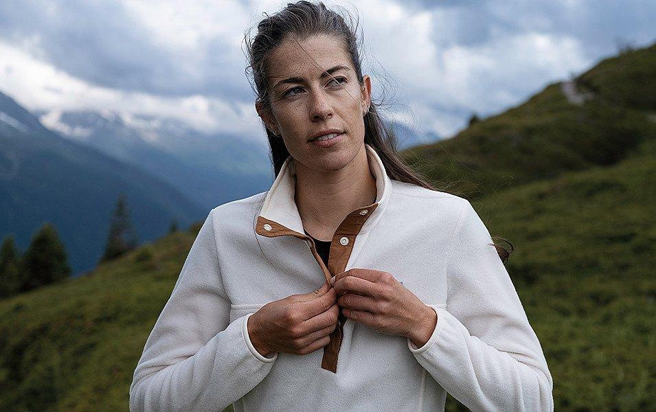 Woman in a white Columbia button up fleece midlayer jacket. 