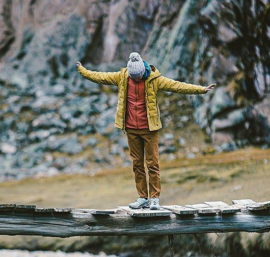Balancing over a skinny wood bridge in the Super/DS hoody