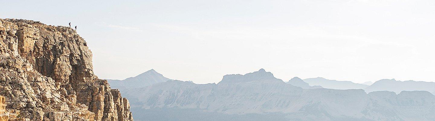 MHW ambassadors, Genevive Walker and Cody Kaemmerlen hike outside of Salt Lake City, way in the distance, both wearing the Super/DS™ Stretchdown Hooded Jacket.
