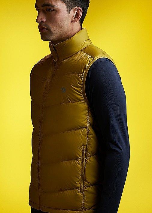 Side profile portrait in studio wearing the Men's Mt. Eyak Vest with a tonal yellow background to match 