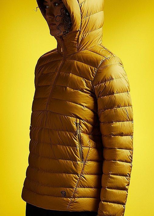 Side profile portrait in studio wearing the Women's Rhea Ridge pullover with a tonal yellow background to match 