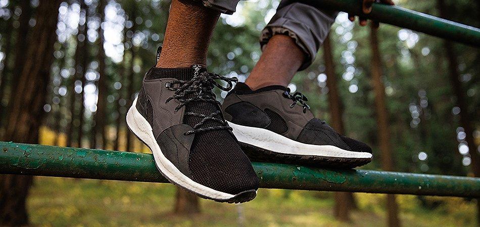 Close-up of black sneakers outdoors.