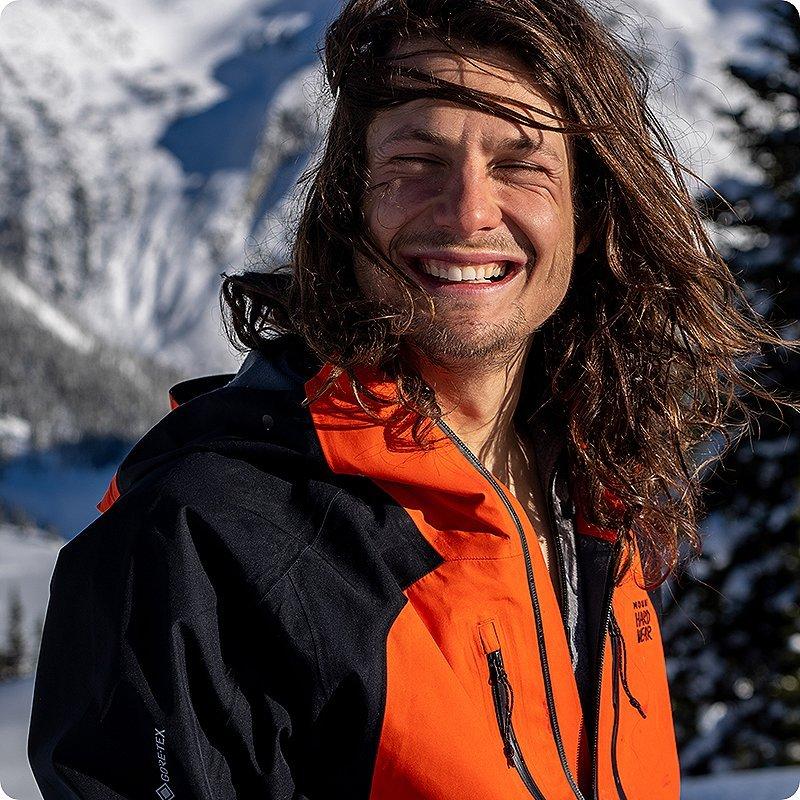 Snowboarder smiling with his eyes closed