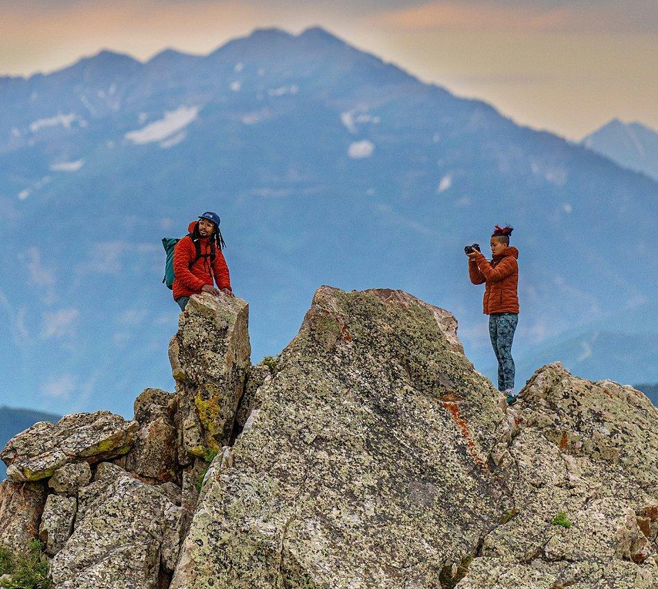 Two 2023 Open Aperture participants taking images on rocks