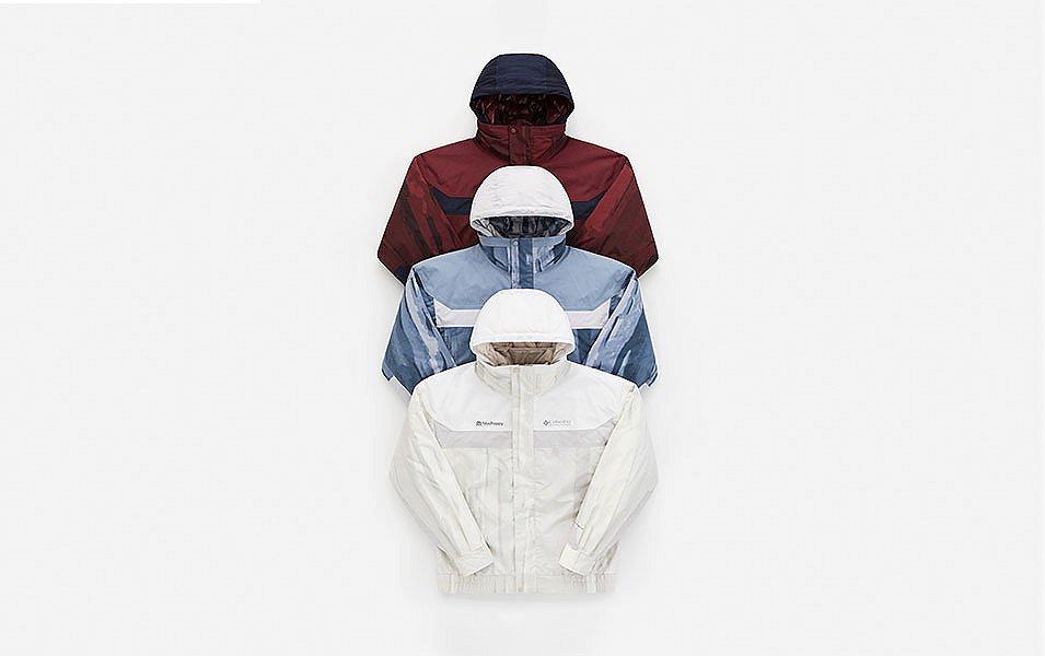 A man and a woman walk away from the camera in a scenic wooded area wearing Madhappy apparel. 