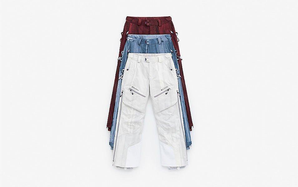 A man and a woman walk away from the camera in a scenic wooded area wearing Madhappy apparel. 