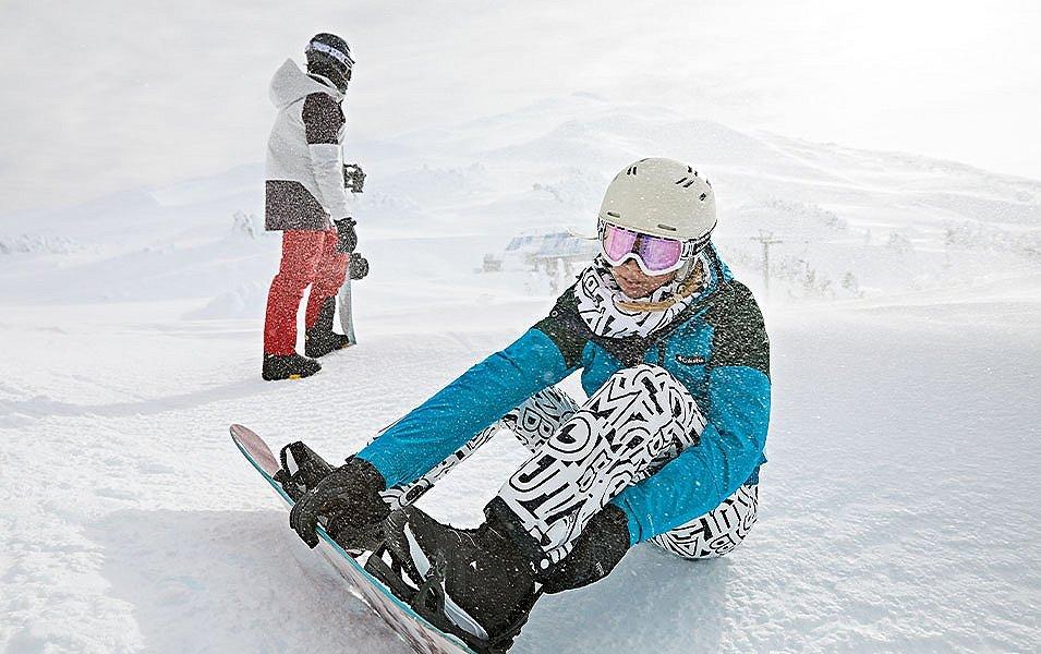 Two snowboarders on a snowy mountain. 