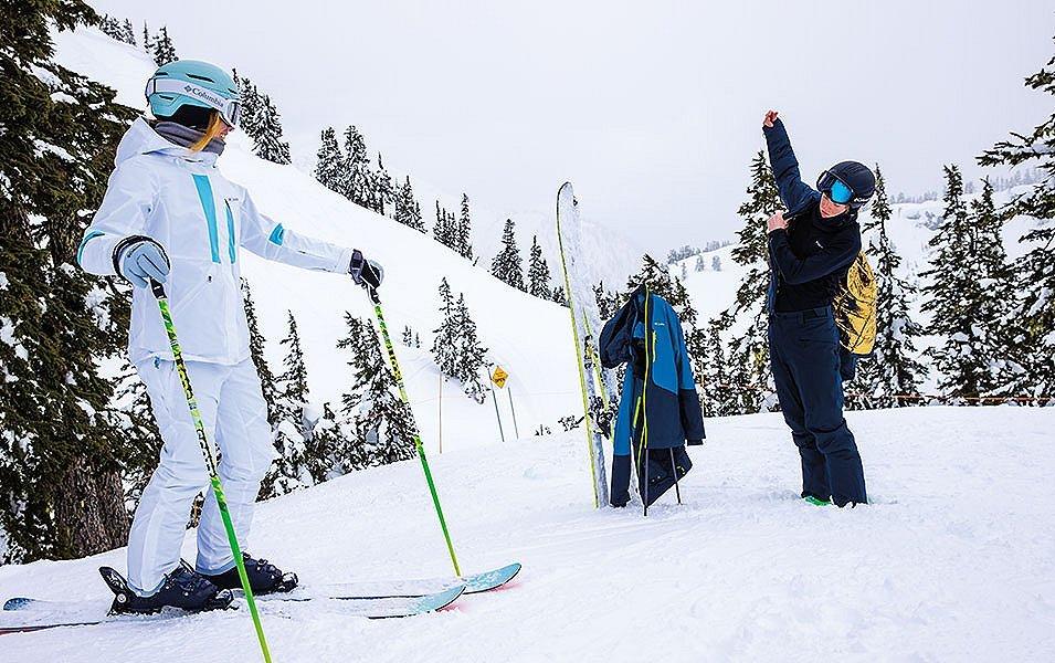 Skiers getting putting on gear. 