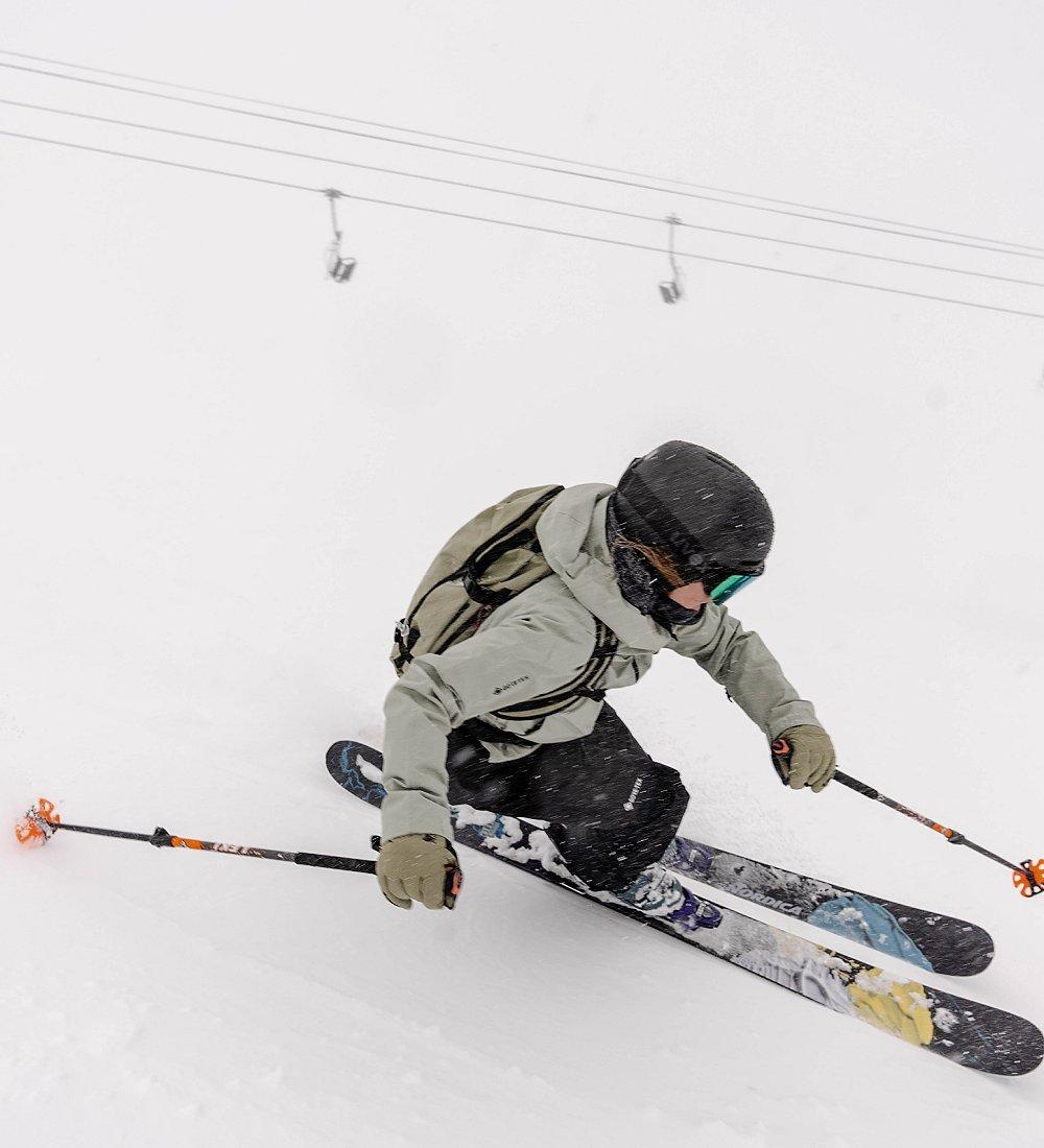 Skiing with chairlifts in the background.