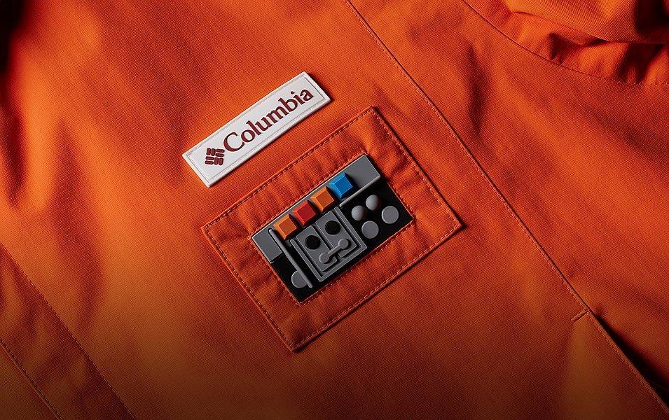Close-up detail of raised-silicone comm link and logo patches. 