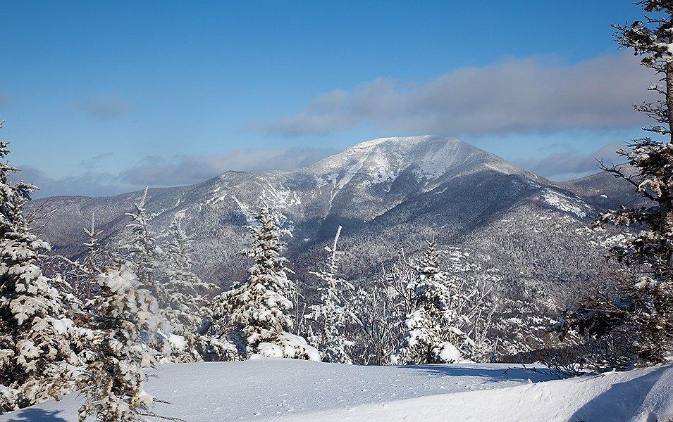 The Adirondacks’ Noonmark Summit is just one of many stunning northeastern mountain ranges that get covered in blankets of snow this time of year.