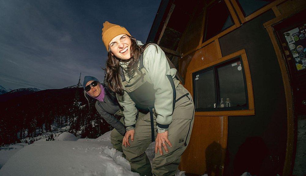 All smiles outside a ski hut at night.