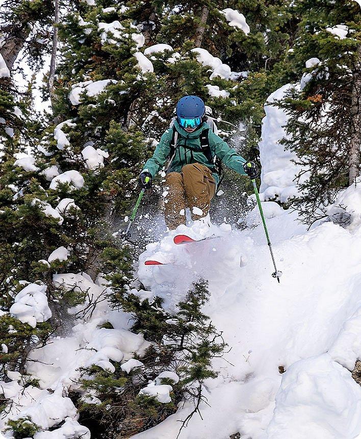 Rachael jumping in a powder day
