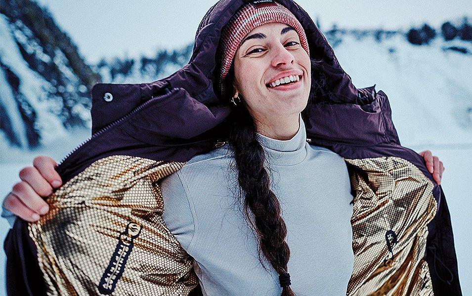 A woman showing the Omni-Heat Infinity lining of a Columbia insulated jacket.