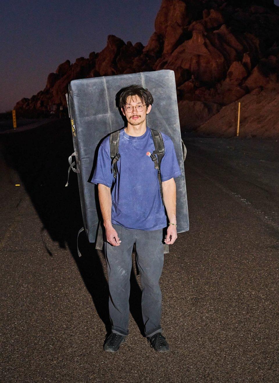 Noah Wheeler carrying a crash pad.