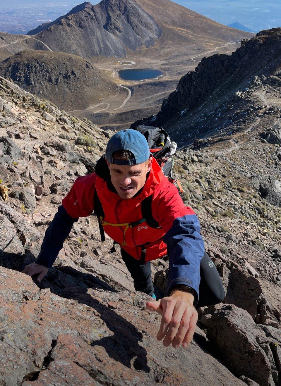Scott Lehmann making him way up rocky terrain.